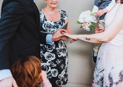 A couple during a marriage ceremony exchanging rings